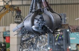 clamshell grabbing scrap in a scrap metal recycling
