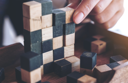 closeup image of people playing and building wooden